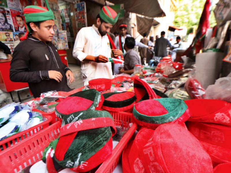 according to stall owners the sale of pti souvenirs has trumped the sale of flags banners and posters of other parties photo muhammad iqbal express