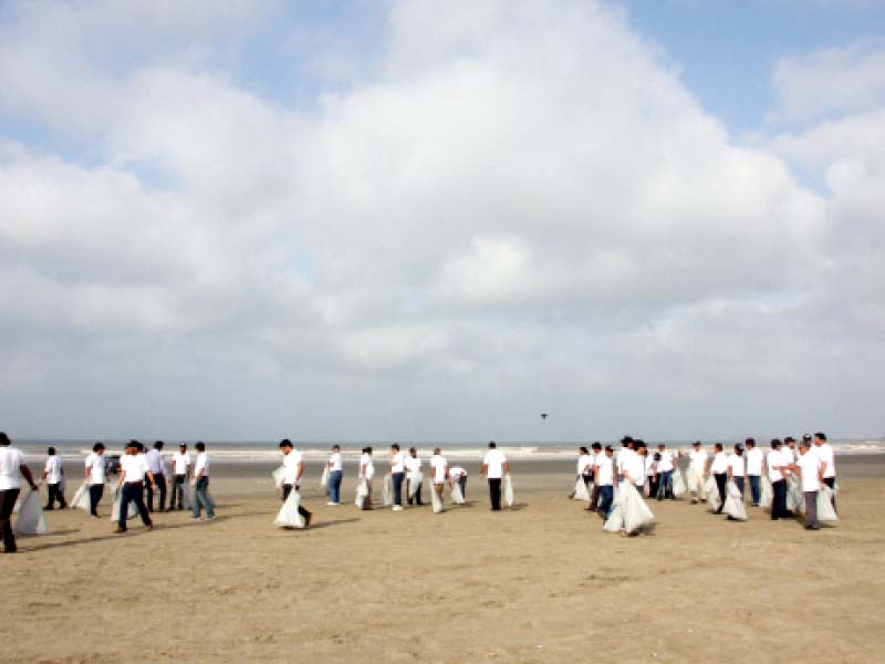 workers of the igi life insurance picked up garbage from the beach at sea view on wednesday morning this was done to mark the third pakistan insurance day photo athar khan express