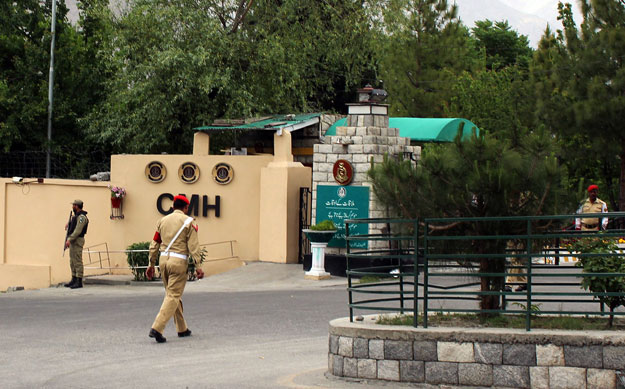 pakistani soldiers stand guard outside a military hospital where victims of a helicopter crash were brought for treatment in gilgit on may 8 2015 photo afp