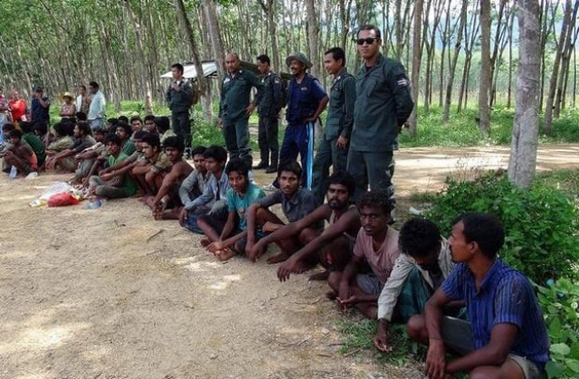 migrants believed to be from myanmar and bangladesh are detained by police in songkhla province on friday photo afp migrants believed to be from myanmar and bangladesh are detained by police in songkhla province on friday photo afp