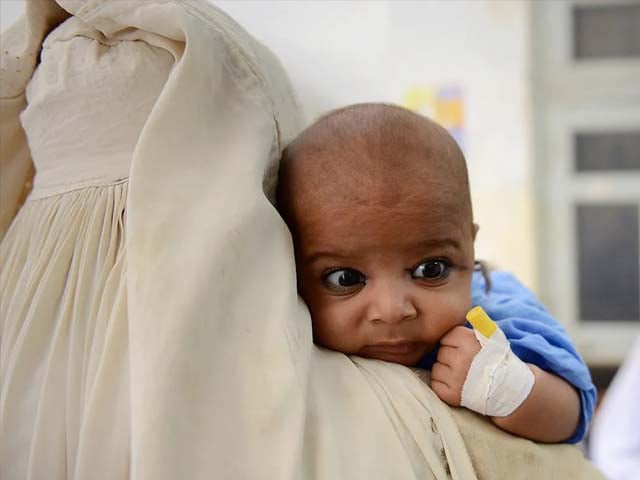 an internally displaced pakistan woman from the north waziristan tribal region carries her sick child photo afp