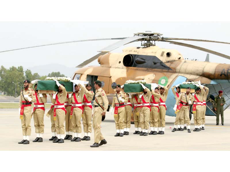 soldiers carry coffins wrapped in national flags and carrying bodies of helicopter crash victims at the nur khan air base in islamabad photo reuters