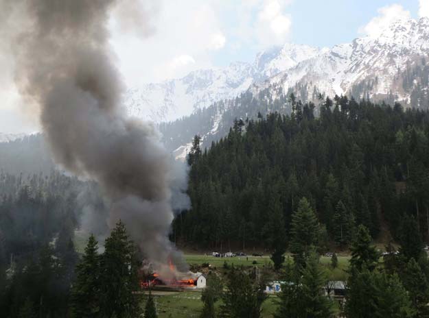 flame and smoke rises from the site where a military helicopter crashed in the northern area of gilgit on may 8 2015 photo afp