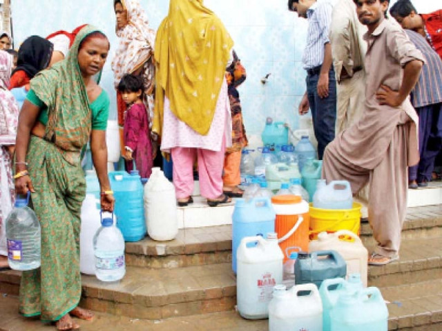 women wait in line with their empty containers to collect water the city has been facing an acute water crisis since the main trunk line was damaged at the dhabeji pumping station last week photo online women wait in line with their empty containers to collect water the city has been facing an acute water crisis since the main trunk line was damaged at the dhabeji pumping station last week photo online