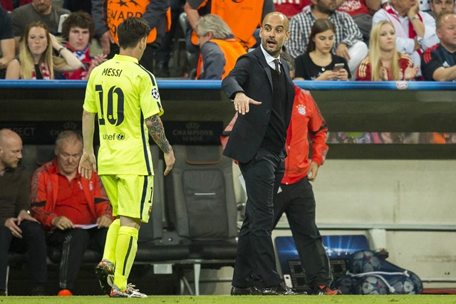 barcelona 039 s argentinian forward lionel messi l is to shake hands with bayern munich 039 s spanish head coach pep guardiola as he leaves the pitch at half time during the uefa champions league football match semi final fc bayern munich vs fc barcelona in munich on may 12 2015 photo afp