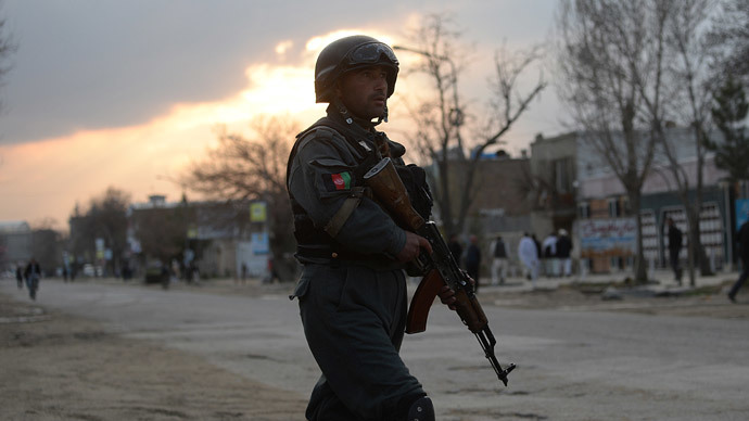 an afghan policeman stands guard near a guesthouse attack by taliban fighters in kabul on march 28 2014 photo afp