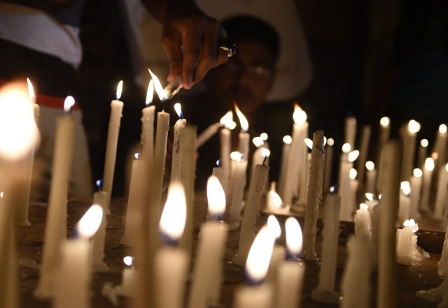 pakistani residents light candles during a vigil for the victims following an attack by gunmen on a shia ismaili minority bus in karachi on may 13 2015 photo afp