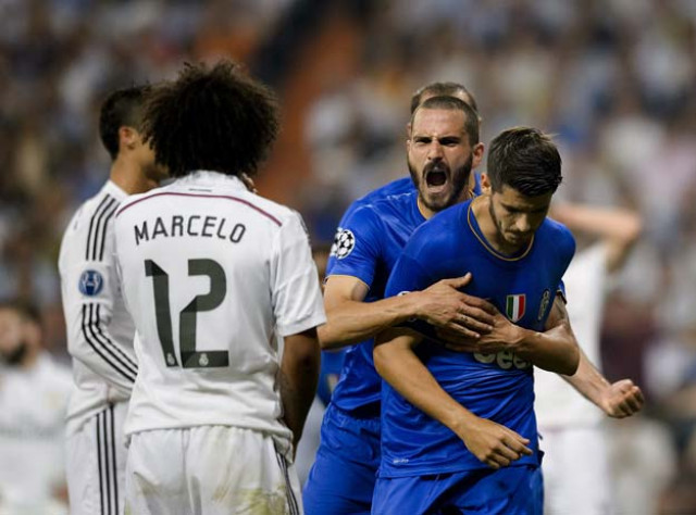 real madrid 039 s brazilian defender marcelo l watches juventus 039 spanish forward alvaro morata r celebrate after scoring during the uefa champions league semifinal second leg football match real madrid fc vs juventus at the santiago bernabeu stadium in madrid on may 13 2015 photo afp real madrid 039 s brazilian defender marcelo l watches juventus 039 spanish forward alvaro morata r celebrate after scoring during the uefa champions league semifinal second leg football match real madrid fc vs juventus at the santiago bernabeu stadium in madrid on may 13 2015 photo afp