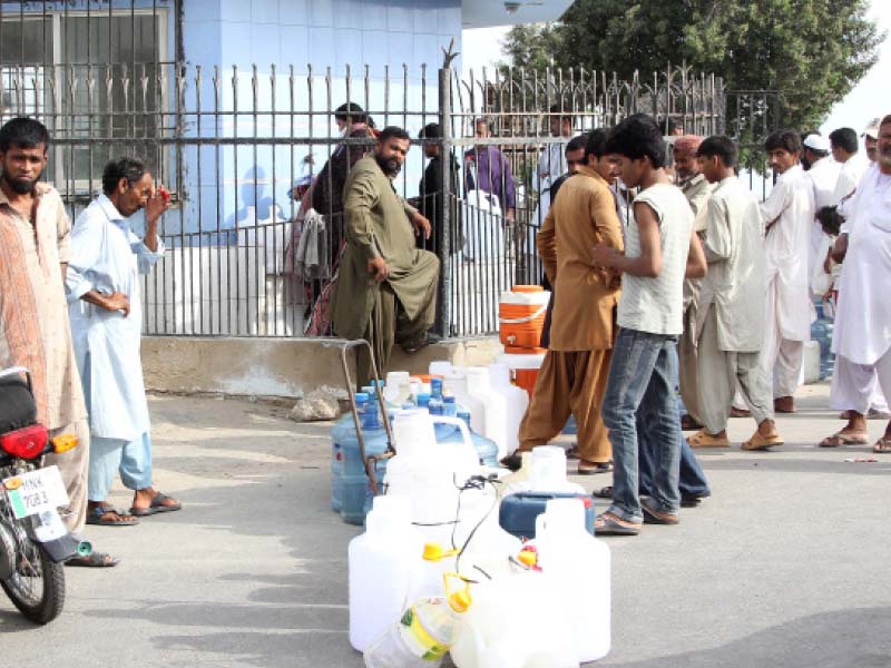 residents queue up at a filling station to fill water as the water shortage in the city reaches critical levels residents complain they have to wait up to three hours to get a can of water photo aysha saleem express