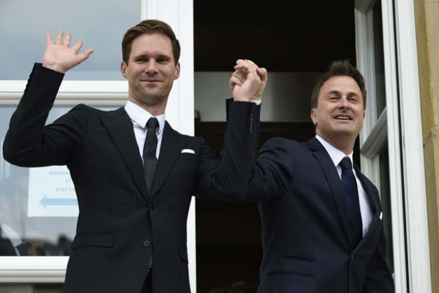 luxembourg prime minister xavier bettel r holds hands with his companion belgian architect gauthier destenay during their wedding in luxembourg on may 15 2015 photo afp luxembourg prime minister xavier bettel r holds hands with his companion belgian architect gauthier destenay during their wedding in luxembourg on may 15 2015 photo afp