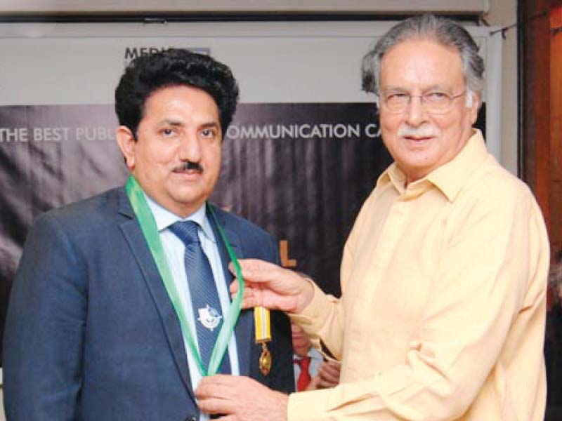 information minister pervaiz rashid presents trust gold medal award 2015 to nab media director nawazish ali khan asim photo inp