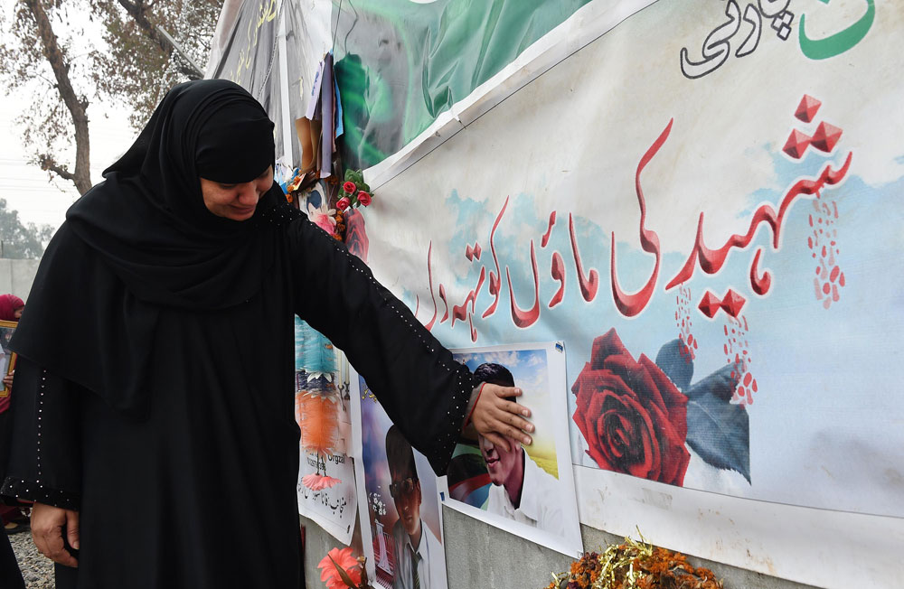 a mother of a schoolchild killed in a taliban attack on the army public school aps reacts during a protest against delays in the investigation in peshawar on february 7 2015 photo afp