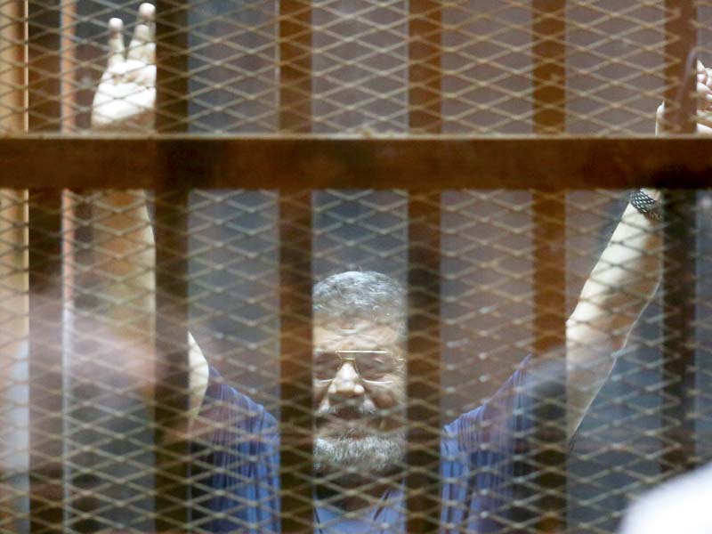 mohamed mursi raises his hands in defiance as the verdict is announced photo reuters