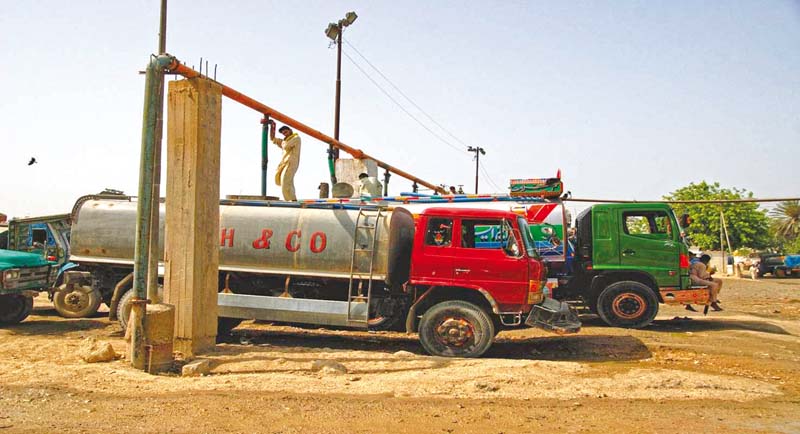 men fill water tankers from a connection in karachi the city s water crisis has worsened recently leaving many of the residents dependent upon services such as these tankers photo courtesy farhan anwar