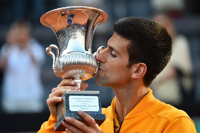 topshots novak djokovic of serbia kisses his trophy after winning the men 039 s final match against swiss roger federer at the atp tennis open on may 17 2015 at the foro italico in rome photo afp