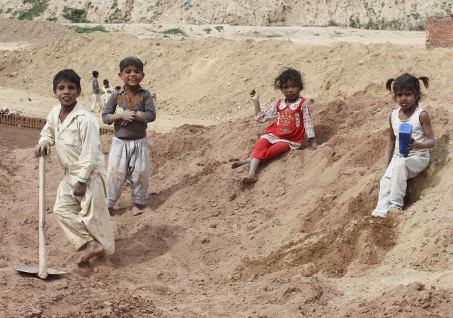 children playing in mud at a brick kiln in islamabad photo inp children playing in mud at a brick kiln in islamabad photo inp