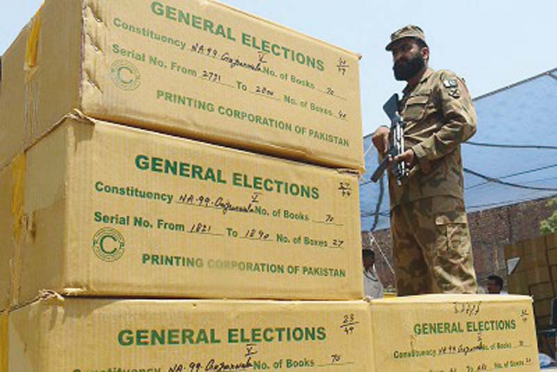 a soldier guards the election material ahead of 2013 polls photo file