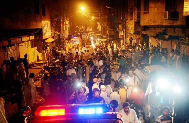 people gathered outside a house after a fire apparently triggered by a short circuit claimed the lives of six children in lahore photo online