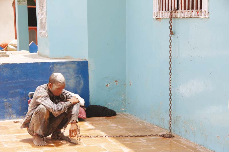 a mentally ill person is tied up in chains at hazrat syed abdullah shah s mazaar in thatta photo credit ayesha mir