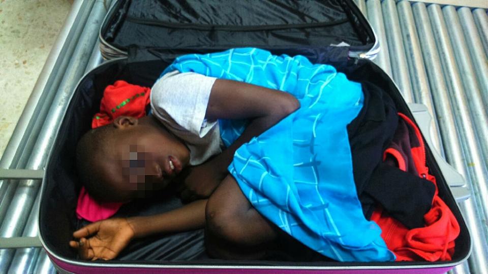 photo from the spanish guardia civil on may 8 2015 shows an 8 year old ivorian boy hidden in a suitcase photo afp