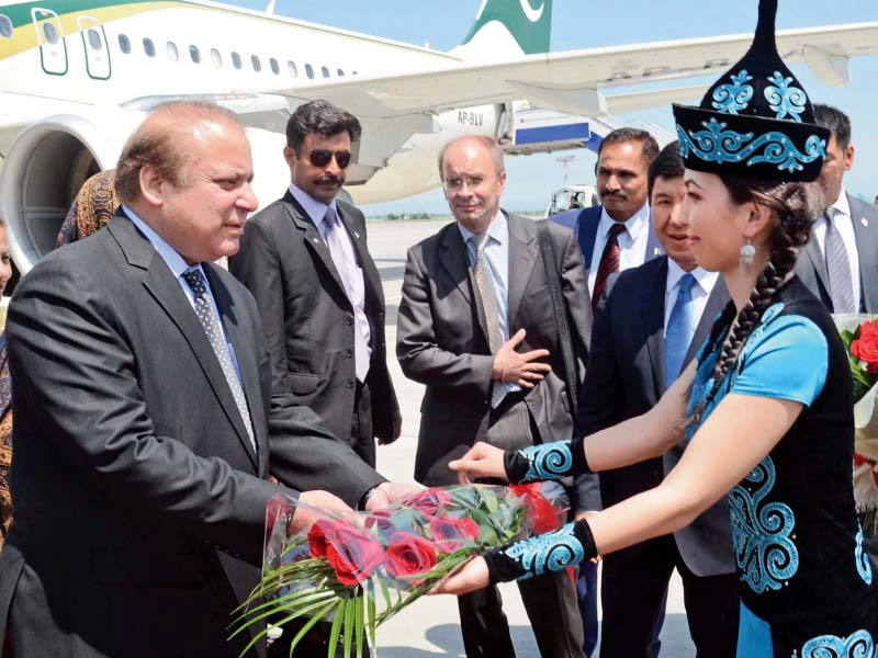 prime minister nawaz sharif gets a traditional welcome on arrival at bishkek airport photo ppi