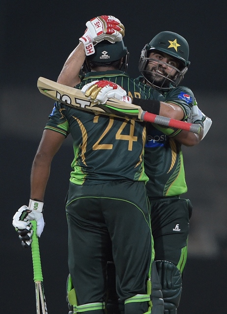 pakistani batsman ahmed shehzad r congratulates to his teammate mukhtar ahmed after scoring 50 runs against zimbabwe during the first international t20 cricket match at the gaddafi cricket stadium in lahore on may 22 2015 photo afp