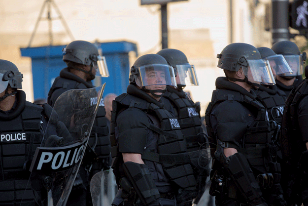 police stand guard during demonstrations in reaction to cleveland police officer michael brelo being acquitted of manslaughter charges after he shot two people at the end of a 2012 car chase in which officers fired 137 shots may 23 2015 in cleveland photo afp