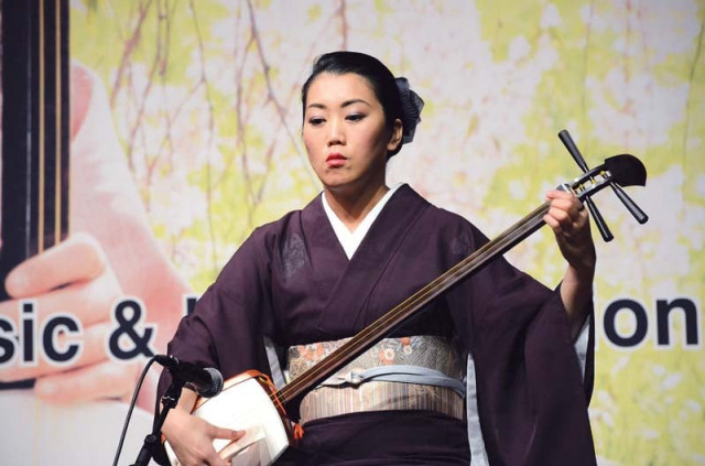 dressed in a traditional kimono dress kaneko played the shamisen a three stringed instrument photo express dressed in a traditional kimono dress kaneko played the shamisen a three stringed instrument photo express