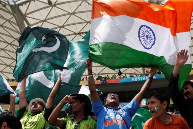 a file photo of pakistan and indian fans hoisting their respective flags photo reuters