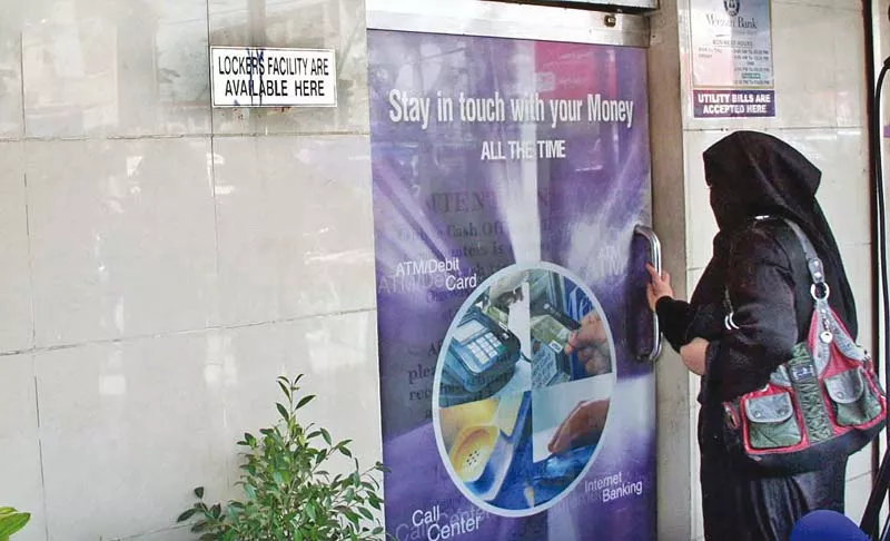 a customer walks into the meezan bank branch that was looted allegedly by its security guard photo online a customer walks into the meezan bank branch that was looted allegedly by its security guard photo online