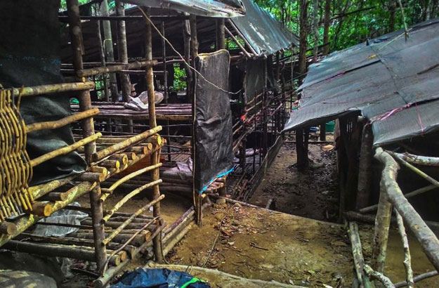 an abandoned migrant detention camp used by people smugglers in a jungle near the malaysia thailand seen in a photo released by the royal malaysian police photo afp