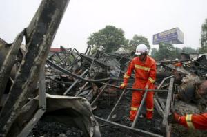 firefighters clean up the debris after a fire at a rehabilitation centre for the elderly in sanlihe village of pingdingshan henan province china may 26 2015 photo reuters