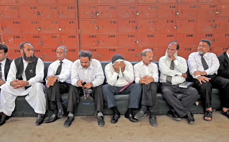 lawyers listen to a speech during a strike at the district city court karachi on tuesday across the province lawyers boycotted court proceedings to protest against the killings of their colleagues in sialkot on monday photo reuters
