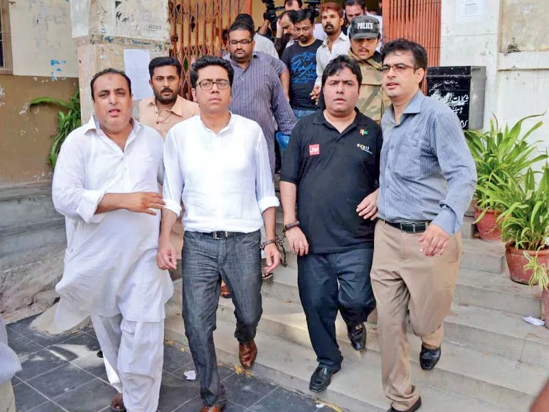 fia officials taking back axact ceo shoaib sheikh and his accomplice after hearing at karachi city court photo express irfan ali fia officials taking back axact ceo shoaib sheikh and his accomplice after hearing at karachi city court photo express irfan ali