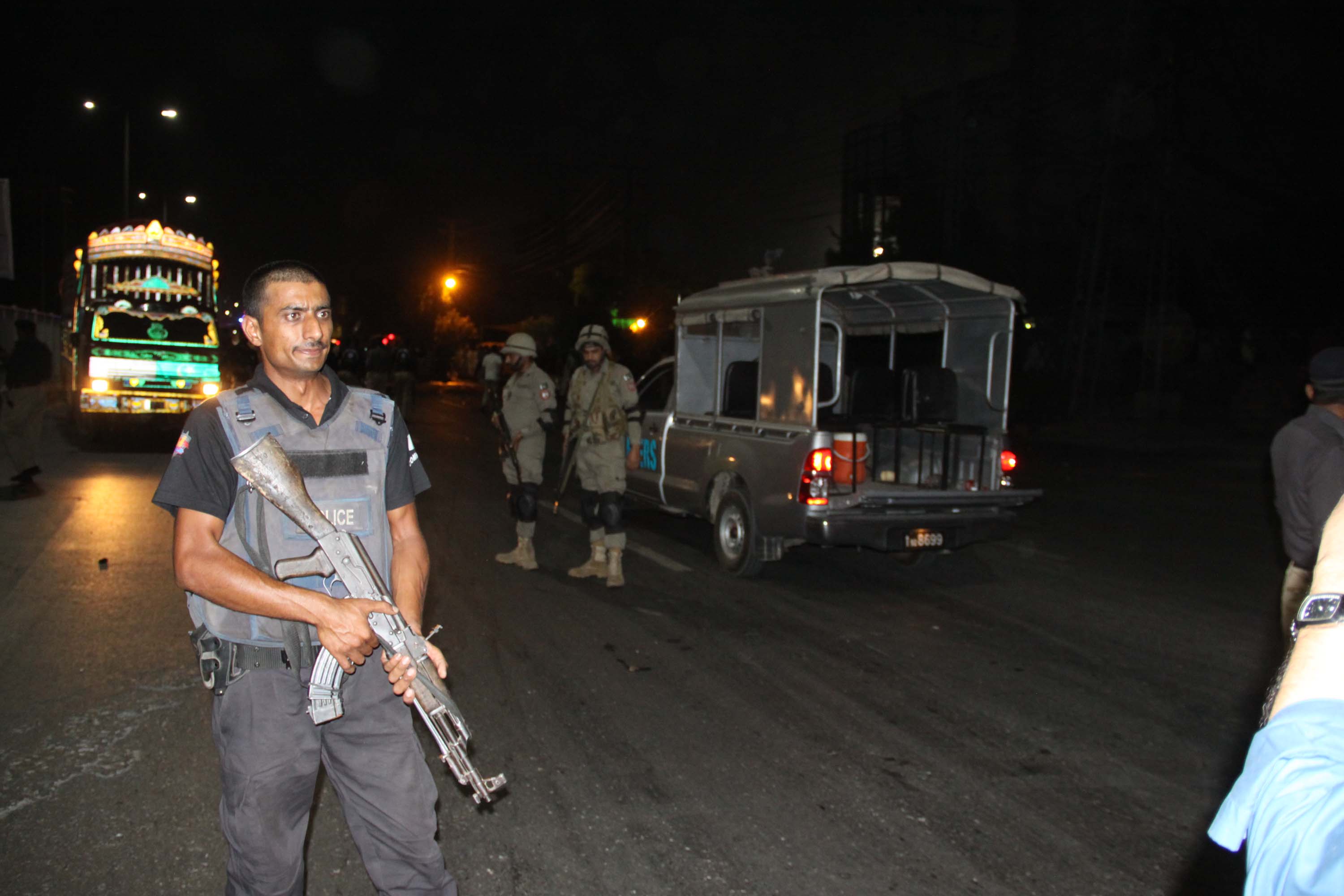 officials stand guard at the site of a cylinder explosion in lahore on friday evening photo abid nawaz express