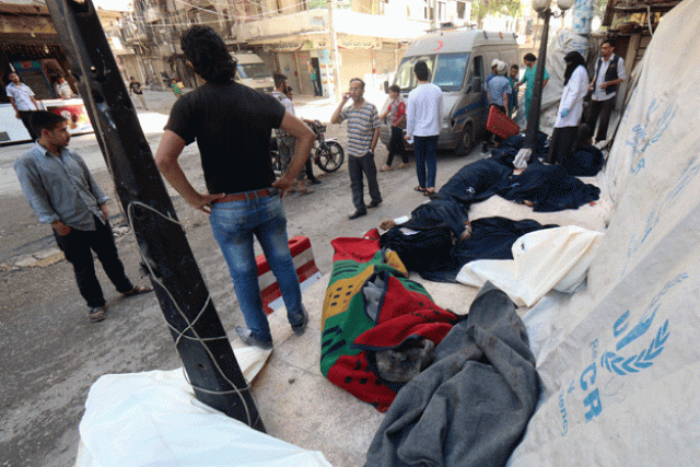 syrians stand next to the bodies of those killed in a reported bomb barrel attack by the syrian airforce on the eastern shaar neighbourhood of the northern syrian city of aleppo on may 30 2015 photo afp syrians stand next to the bodies of those killed in a reported bomb barrel attack by the syrian airforce on the eastern shaar neighbourhood of the northern syrian city of aleppo on may 30 2015 photo afp