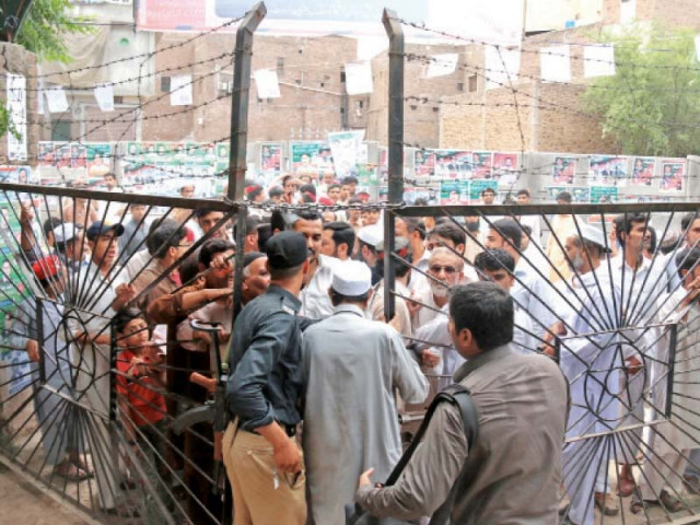 voters wait to be allowed to enter the polling station set up in ganj tb center photo muhammad iqbal express