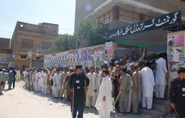 voters waiting to cast their votes photo express voters waiting to cast their votes photo express