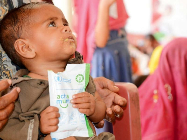 a child eats fortified food provided by wfp in tharparkar photo file a child eats fortified food provided by wfp in tharparkar photo file