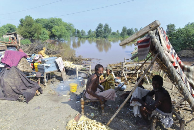 men take shelter at a relief camp in muzaffargarh photo file men take shelter at a relief camp in muzaffargarh photo file