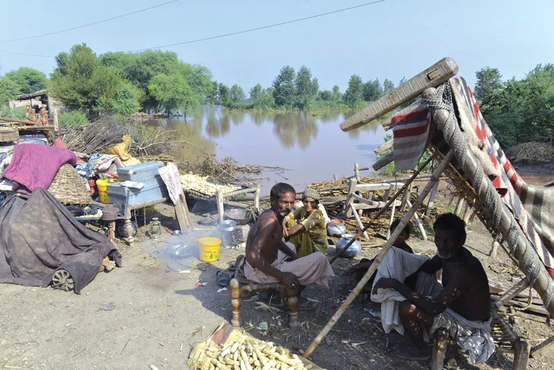men take shelter at a relief camp in muzaffargarh photo file men take shelter at a relief camp in muzaffargarh photo file