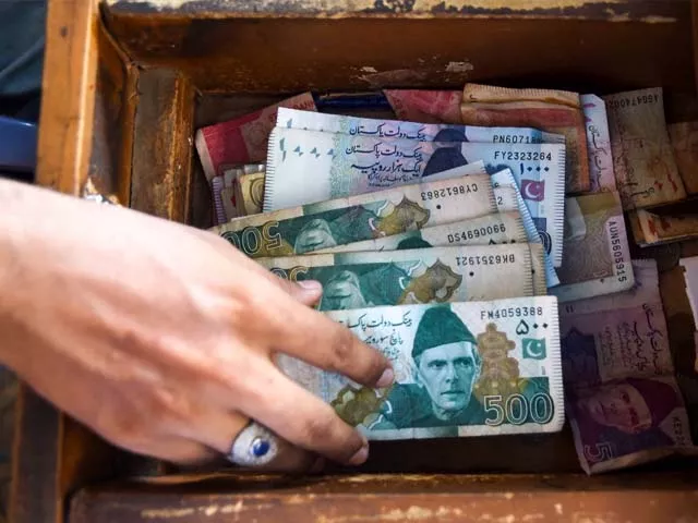 a pakistani man counts pakistan 039 s rupees at his shop in karachi photo getty a pakistani man counts pakistan 039 s rupees at his shop in karachi photo getty