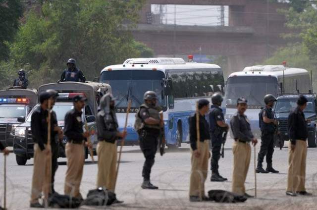 police commandos stand guard as buses carrying the zimbabwe and pakistani cricket teams arrive at the gaddafi cricket stadium in lahore on may 31 2015 photo afp police commandos stand guard as buses carrying the zimbabwe and pakistani cricket teams arrive at the gaddafi cricket stadium in lahore on may 31 2015 photo afp
