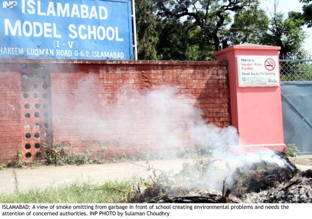 wastage is set on fire right outside a school in islamabad on wednesday photo inp wastage is set on fire right outside a school in islamabad on wednesday photo inp