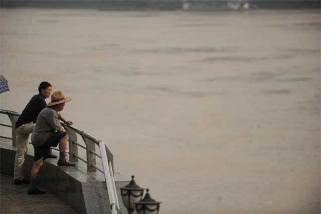 people look out onto the yangtze river in chongqing photo afp people look out onto the yangtze river in chongqing photo afp