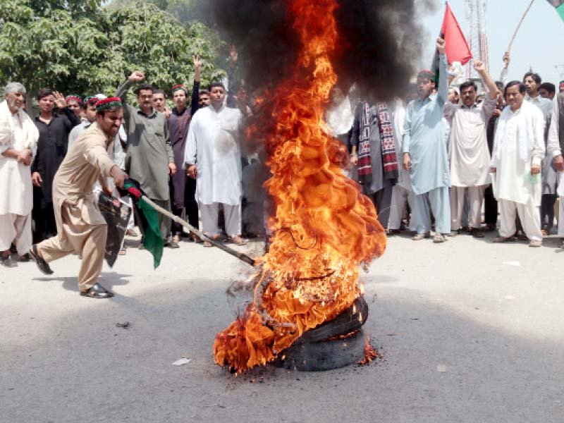 pakistan peoples party workers set fire to tyres outside the peshawar press club photo muhammad iqbal express
