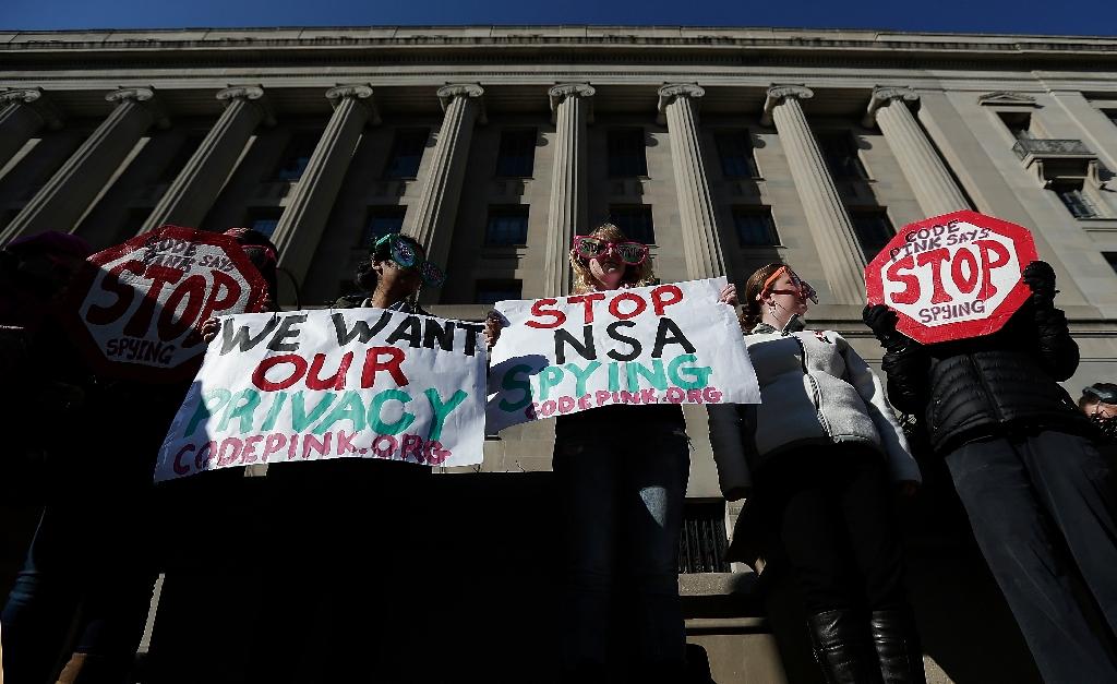 activists protest the surveillance of us citizens by the nsa outside the justice department where president barack obama gave a speech on reforming the nsa january 17 2014 in washington dc photo afp