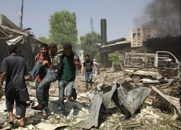 syrian men help an injured person after a reported barrel bomb attack by syrian government forces hit an open market in the northern city of aleppo on june 3 2015 killing and injuring people photo afp