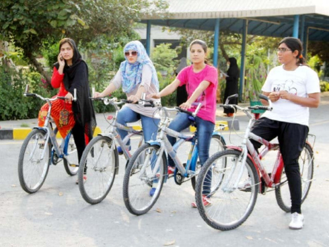 a group of girls prepare for their first bicycle ride on the campus photo shamsul islam express