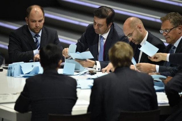 officials sift through ballots as counting got underway following the vote to decide on the fifa presidency in zurich on may 29 2015 photo afp officials sift through ballots as counting got underway following the vote to decide on the fifa presidency in zurich on may 29 2015 photo afp